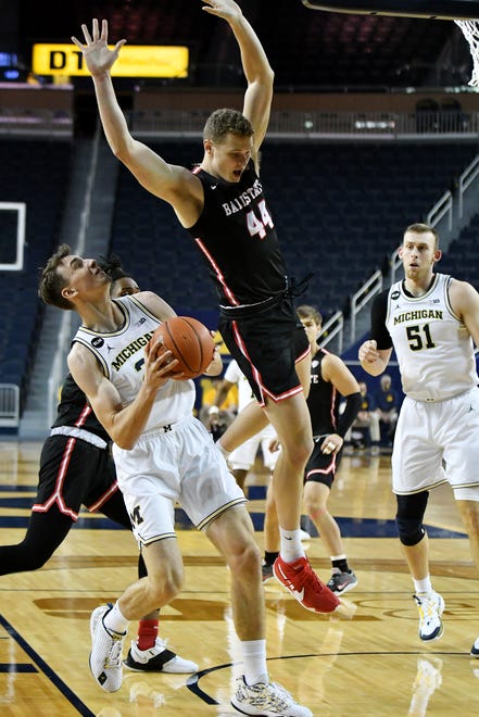 Ball State center Blake Huggins (44) defends a shot by Michigan guard Franz Wagner (21) in the first half.