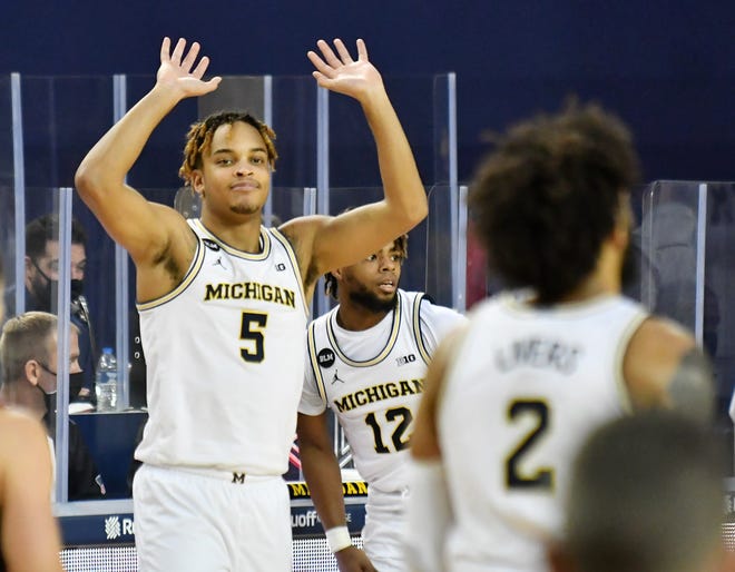 Michigan forward Terrance Williams II (5) reacts to a dunk by forward Isaiah Livers (2) in the second half of a game against Ball State on Dec. 2.