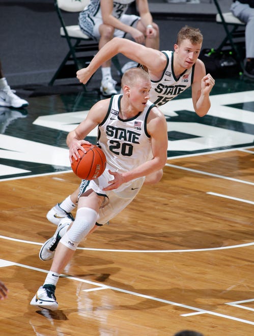 Michigan State's Joey Hauser, left, was scheduled to play against his older brother Sam, who is a senior forward on Virginia.