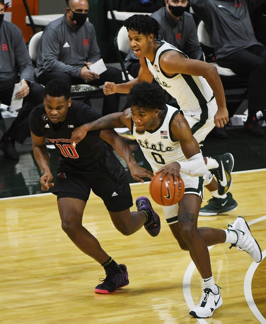 Michigan State's Aaron Henry is off to the races, charging down the court against  Rutgers' Montez Mathis on a stolen ball in the second half.