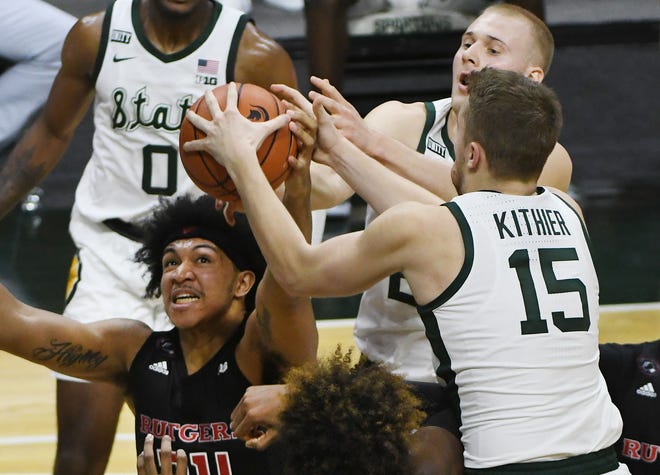 Rutgers' Ron Harper Jr. and Michigan State's Joey Hauser and Thomas Kithier battle for a rebound in the second half.