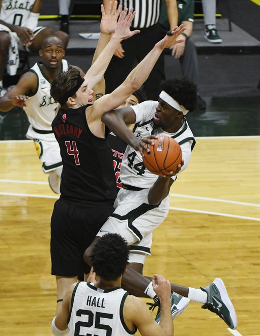 Rutgers' Paul Mulcahy defends against Michigan State's Gabe Brown driving to the basket in the second half. NCAA Michigan State University basketball vs. Rutgers at the Breslin Center in E. Lansing, Michigan  on Jan. 5, 2021.
