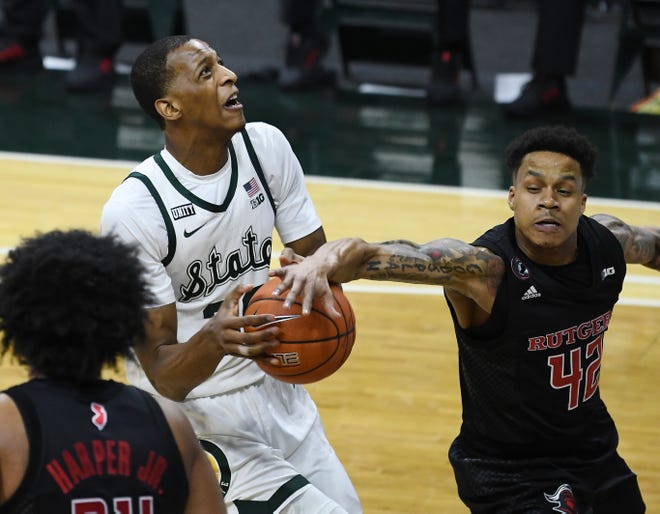 Michigan State's Marcus Bingham Jr. gets the ball stolen by Rutgers' Jacob Young in the first half.