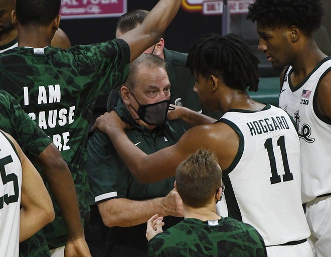 Michigan State's  A.J. Hoggard puts his hands on coach Tom Izzo shoulders as he talks to the freshman as he comes to the bench in the second half.