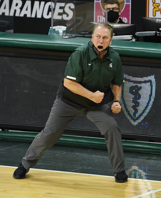 Michigan State head coach Tom Izzo gets physical on the sideline calling out to his players.
