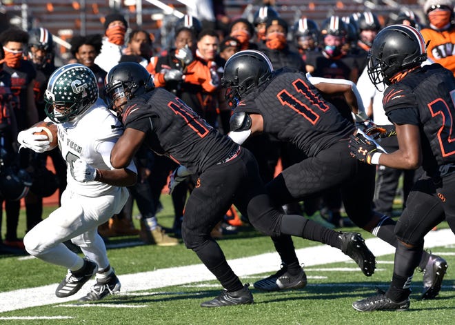 Cass Tech's Karriem Sharrieff (30) is pushed out of bounds by a host of Belleville players in the first quarter.