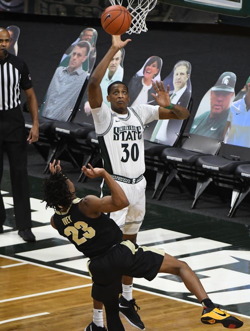 Michigan State's Marcus Bingham Jr. blocks Purdue's Jaden Ivey, holding Purdue to 16 points in the first half.