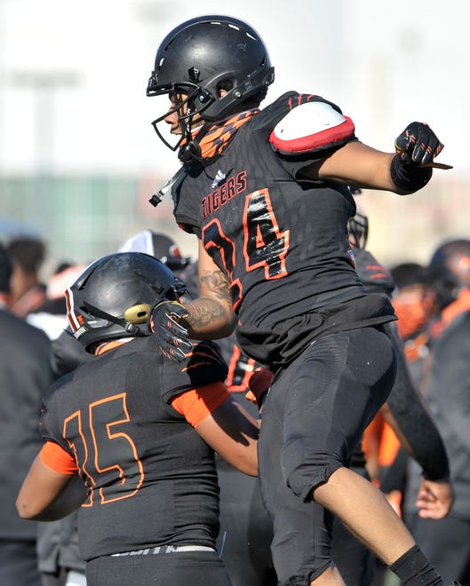 Belleville's Kobe Langford (24) celebrates with Cameron Jones (15) after Langford's rushing touchdown in the first quarter.