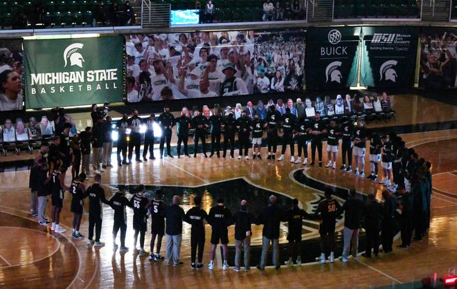 Both Michigan State and Purdue basketball teams come together in a unity circle before the start of the game at the Breslin Center.