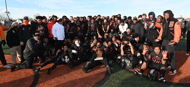 Members of the Belleville High School football team pose for their team picture after beating Cass Tech, 43-16.