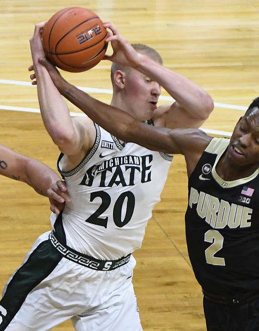 Michigan State's Joey Hauser is fouled by Purdue's Eric Hunter Jr. in the first half of their NCAA  basketball game at the Breslin Center in East Lansing, Michigan, Friday, January 8, 2021.
