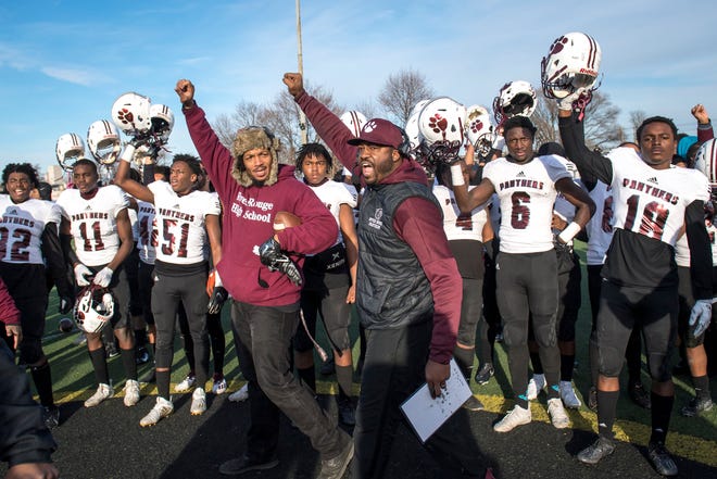 River Rouge head coach Corey Parker celebrates with his team after the 33-30 win against Detroit King at Detroit King in Detroit, Mich on Jan. 9, 2021.