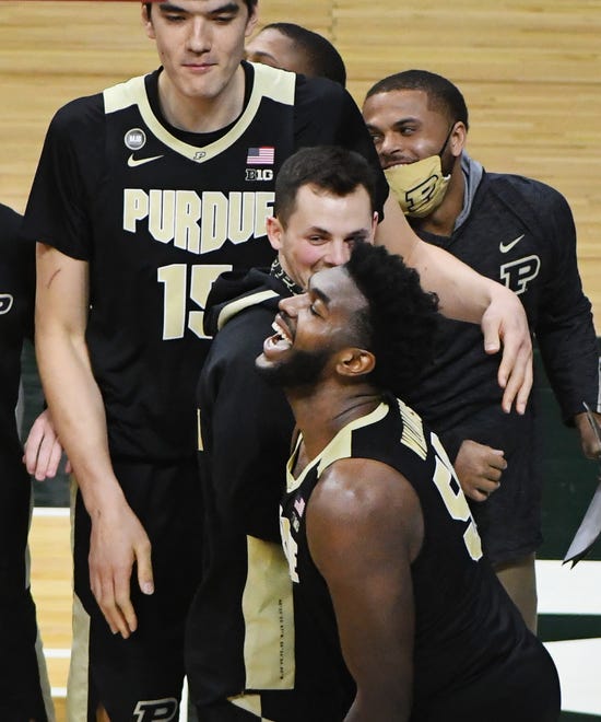 Purdue's Trevion Williams celebrates with teammates after hitting the game-winning shot to beat Michigan State 55-54.