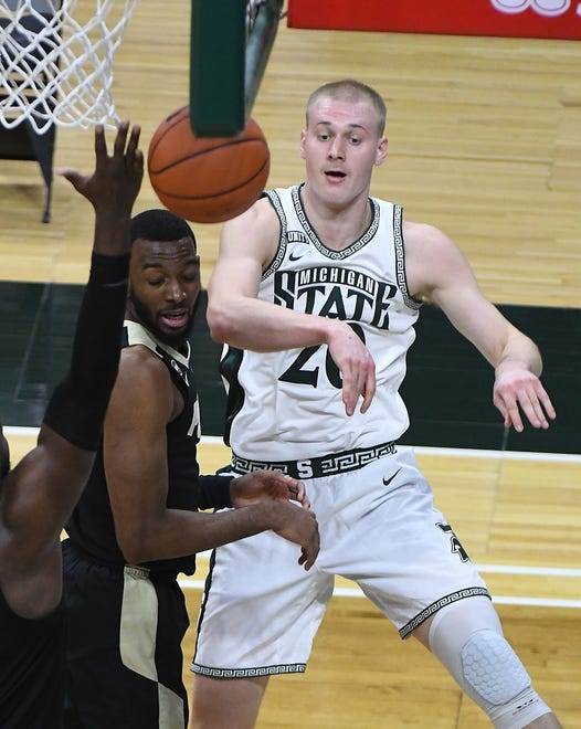 Michigan State's Joey Hauser passes out of pressure  in the second half.