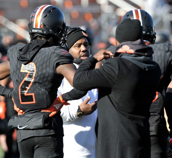 Belleville head coach Jermain Crowell talks to his team at the beginning of the second quarter.