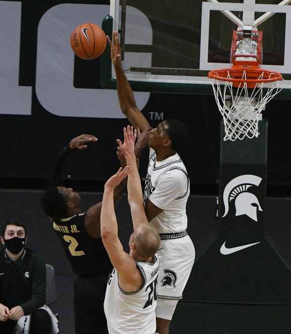 Michigan State's Marcus Bingham Jr. blocks Purdue's Eric Hunter at the end of the first half,  holding Purdue to 16 points for the half.