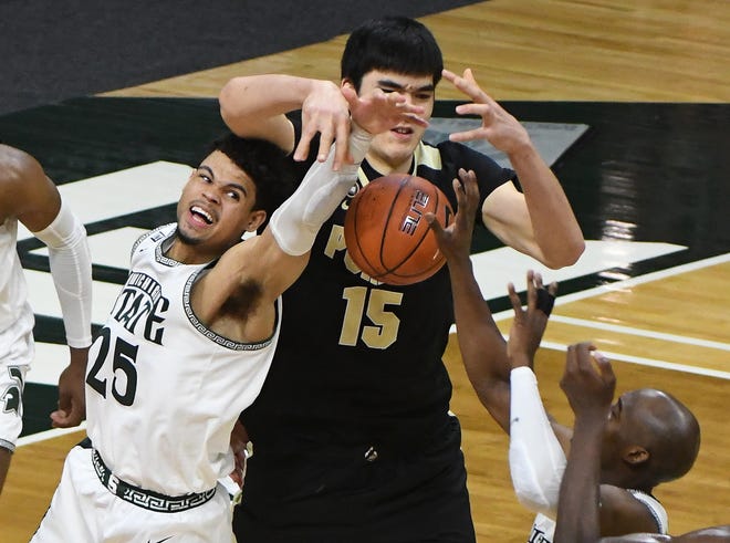 Michigan State's Malik Hall and Joshua Langford fight for a rebound with Purdue's Zach Edey with Purdue eventually keeping possession, which led to the game-winning shot, near the end of the second half.