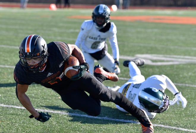 Belleville's Tyree Lockett (5) dives for extra yardage in the second quarter.