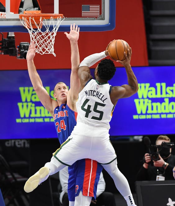 Jazz's Donovan Mitchell scores over Pistons' Mason Plumlee in the first quarter.