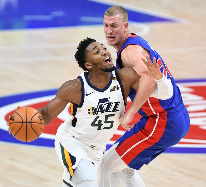 Jazz's Donovan Mitchell is fouled by Pistons' Mason Plumlee in the third quarter.