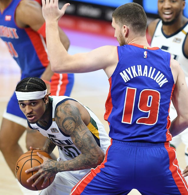 Jazz's Jordan Clarkson drives around Pistons' Svi Mykhailiuk in the third quarter.