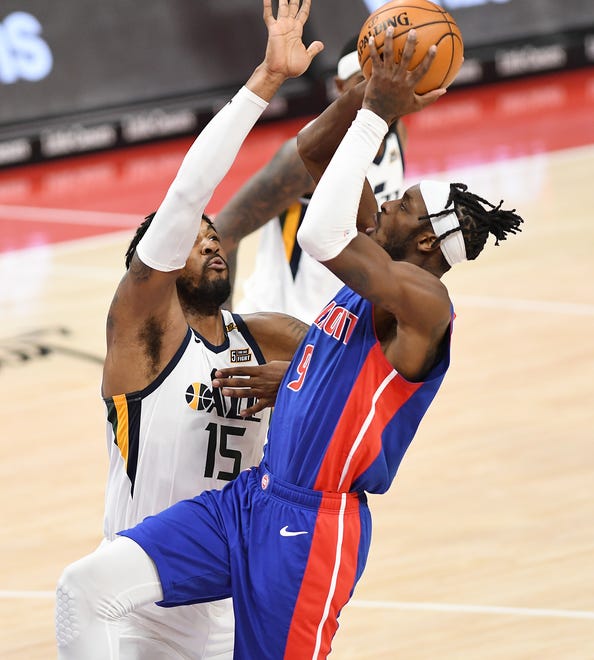 Pistons' Jerami Grant shoots over Jazz's Derrick Favors in the fourth quarter.