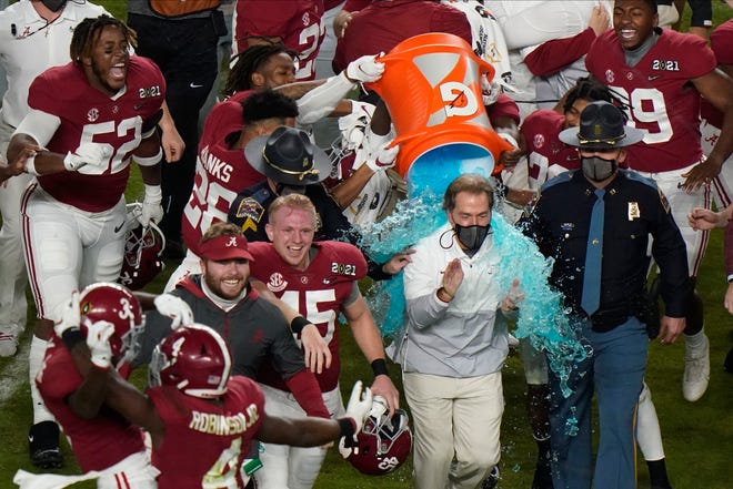 Alabama head coach Nick Saban is soaked in a sports drink after their win against Ohio State.