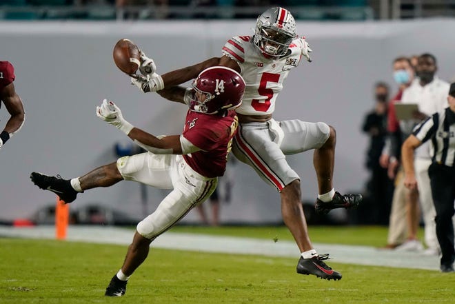 Alabama defensive back Brian Branch breaks up a pass intended for Alabama wide receiver Javon Baker during the first half.