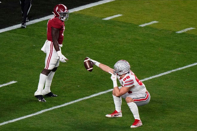 Ohio State tight end Jeremy Ruckert celebrates after a catch as Alabama linebacker Christian Harris looks on during the first half.