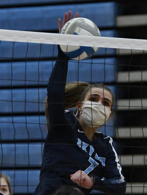 Skyline's  Sophie Schrag slams home a shot over the net against Novi in the second game.