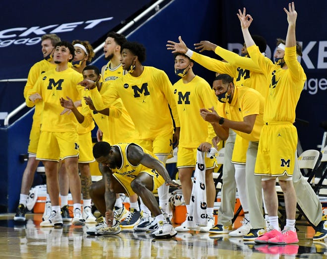 Michigan bench reacts in the second half against Wisconsin at Crisler Center in Ann Arbor.