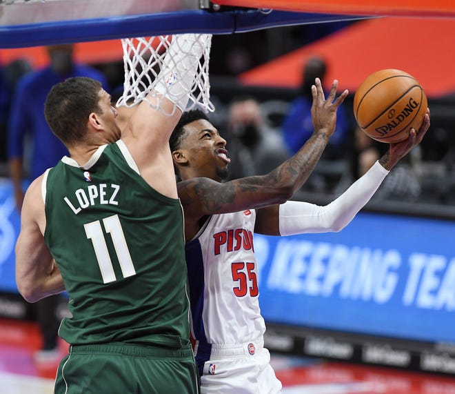 Pistons' Delon Wright shoots over Bucks' Brook Lopez in the first quarter.