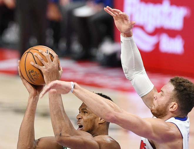 Bucks' Giannis Antetokounmpo grabs a rebound in front of Pistons' Blake Griffin in the third quarter.