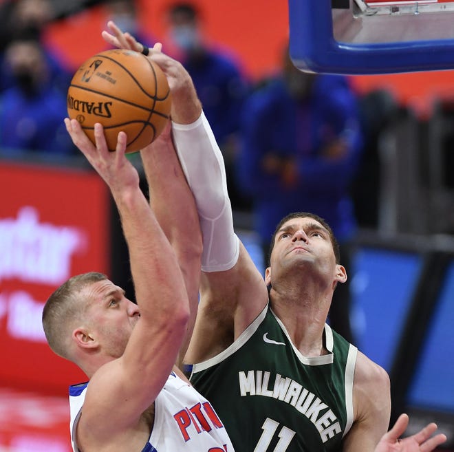 Bucks' Brook Lopez blocks the shot of Pistons' Mason Plumlee in the first quarter. Lopez had 4 block shots and 11 rebounds. The Bucks defeated the Pistons, 110-101, Wednesday, January 13, 2021 at Little Caesars Arena in Detroit, Michigan.