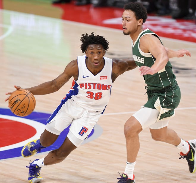 Pistons' Saben Lee drives around Bucks' Bryn Forbes in the second quarter.