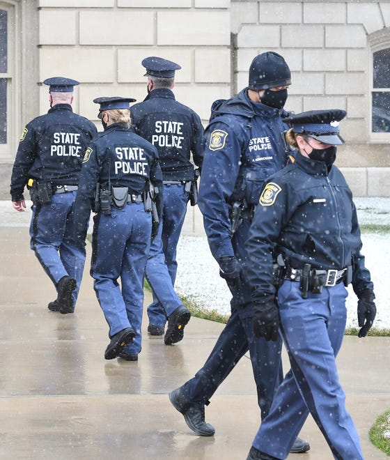 Michigan State Police patrol the Michigan State Capitol on Friday morning in Lansing.