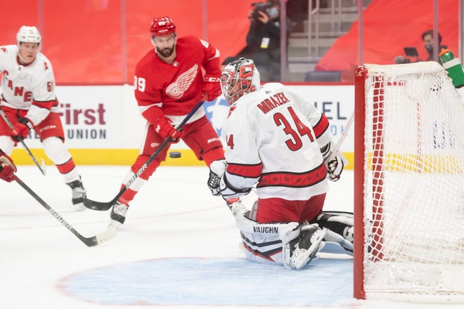 Detroit center Sam Gagner tries to shoot the puck past Carolina goaltender Petr Mrazek in the first period during a game between the Detroit Red Wings and the Carolina Hurricanes, at Little Caesars Arena, in Detroit, January 14, 2021.