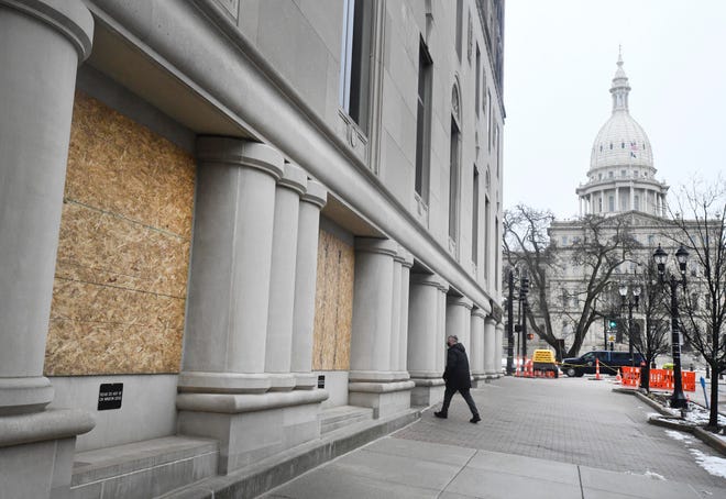 Boarded up windows along Michigan Ave. with the Michigan State Capital building in the distance, in preparation for possible protests around the capital over the weekend, in Lansing, Michigan on January 15, 2021.