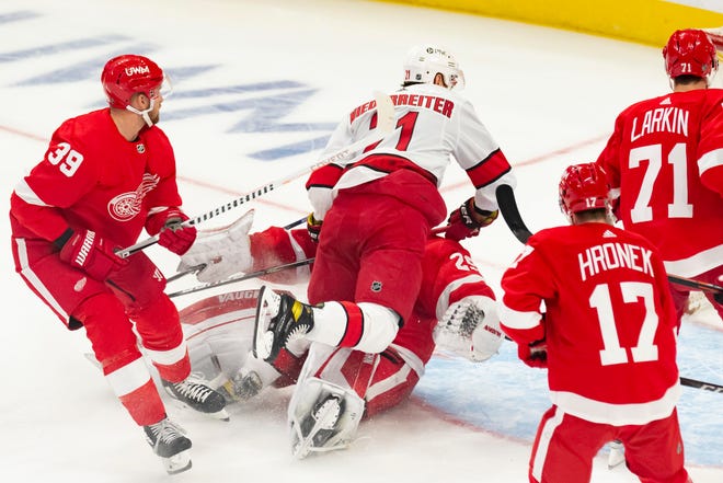 Carolina right wing Nino Niederreiter crashes into Detroit goaltender Thomas Greiss after scoring a goal in the first period during a game between the Detroit Red Wings and the Carolina Hurricanes, at Little Caesars Arena, in Detroit, January 14, 2021.