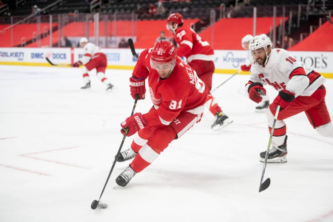 Detroit center Frans Nielsen keeps the puck away from Carolina center Vincent Trocheck in the second period during a game between the Detroit Red Wings and the Carolina Hurricanes, at Little Caesars Arena, in Detroit, January 14, 2021.