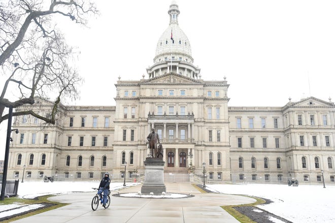 Michigan State Police officers patrol around the Michigan State Capital Friday morning on bicycle in Lansing, Michigan on January 15, 2021.
