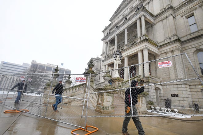 Workers with National Construction Rentals put up security fencing around the Michigan State Capital in preparation for possible protests over the weekend, in Lansing, Michigan  on January 15, 2021.