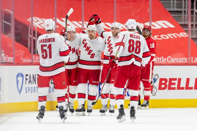 Carolina celebrates a goal by center Ryan Dzingel in the third period during a game between the Detroit Red Wings and the Carolina Hurricanes, at Little Caesars Arena, in Detroit, January 14, 2021.
