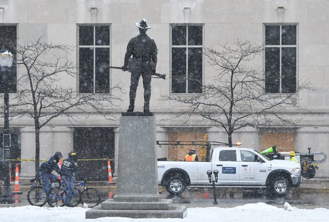 Michigan State Police patrol around the George W. Romney State Office Building, where Gov. Gretchen Whitmer has her main offices, as windows are being boarded up in preparations for possible protests over the weekend in Lansing, Michigan  on January 15, 2021.