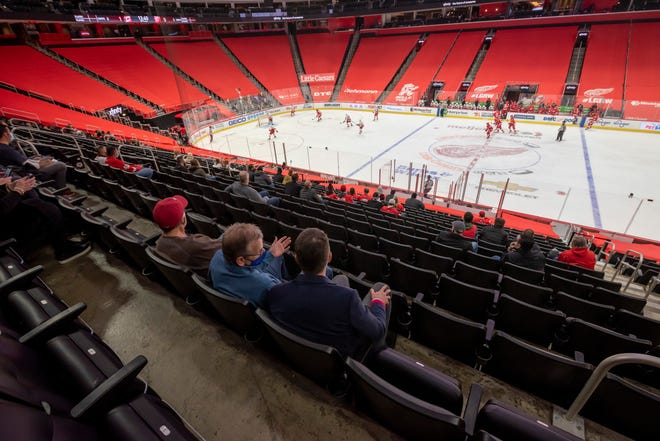 Due to COVID-19 restrictions a limited number of fans were allowed in during a game between the Detroit Red Wings and the Carolina Hurricanes, at Little Caesars Arena, in Detroit, January 14, 2021.