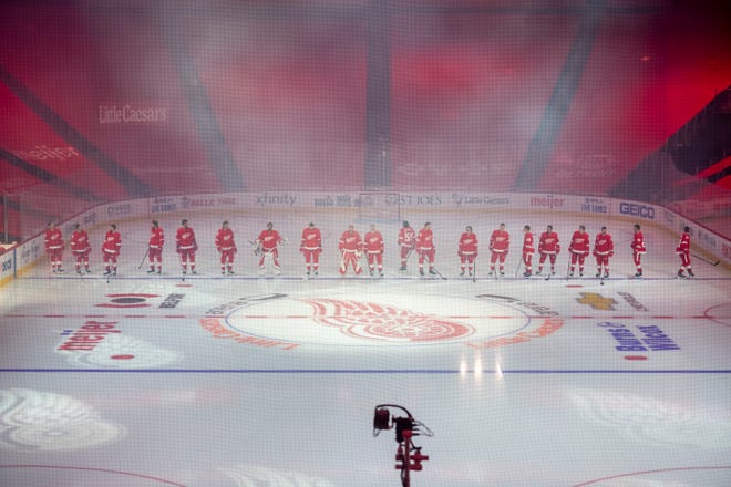 The Red Wings line up as they are introduced as part of the home opener ceremony during a game between the Detroit Red Wings and the Carolina Hurricanes, at Little Caesars Arena, in Detroit, January 14, 2021.