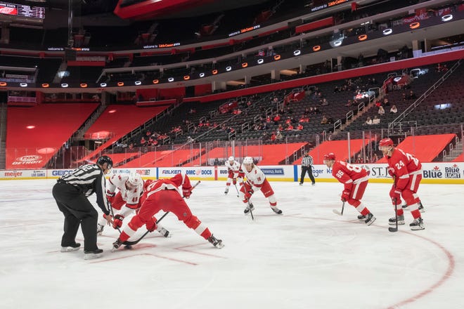 The two teams line up for a face off in the second period during a game between the Detroit Red Wings and the Carolina Hurricanes, at Little Caesars Arena, in Detroit, January 14, 2021. Due to COVID-19 restrictions a limited number of fans were allowed into the game.