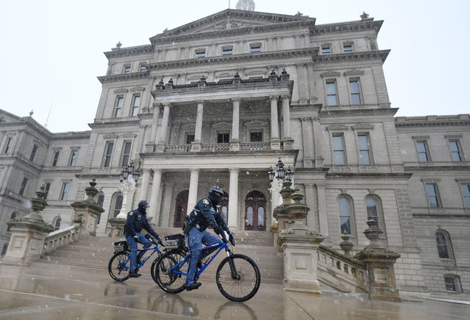Michigan State Police patrol around the Michigan State Capitol Friday morning in Lansing, Michigan  on January 15, 2021.