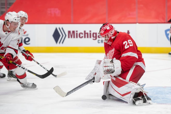 Detroit goaltender Thomas Greiss stops a shot in the second period during a game between the Detroit Red Wings and the Carolina Hurricanes, at Little Caesars Arena, in Detroit, January 14, 2021.