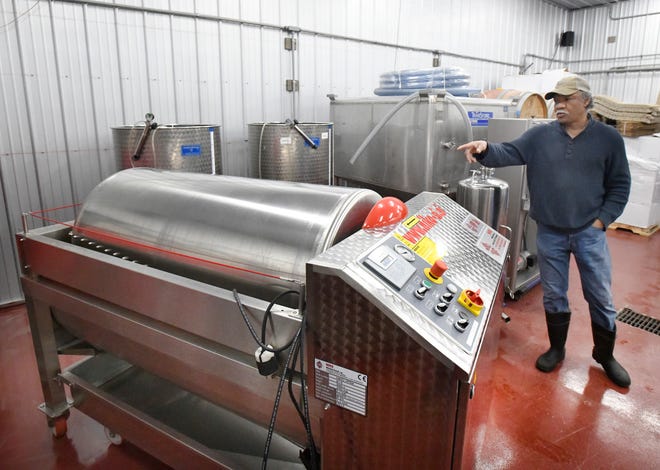 No longer are you stomping grapes by foot, Black Fire Winery owner Michael Wells shows off an automatic wine press that does all the work, without anyone getting purple feet.